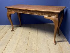 A light honey coloured oak sidetable with cabriole legs below a shaped frieze 161cmL x 54cm X 80cmH