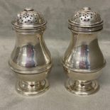 Pair of Sterling silver sugar sifters or muffiniers by Sebastian Henry Garrard, (Garrard & Co)