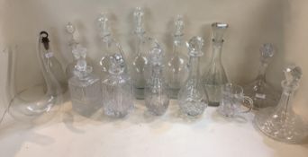 A quantity of glass decanters and stoppers, mainly modern