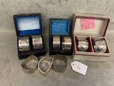 A collection of Sterling silver napkin rings to include 3 boxed pairs and 3 single examples, various