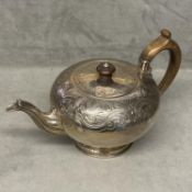 A Georgian sterling silver teapot of bulbous form with chased decoration, fruitwood handle & finial,