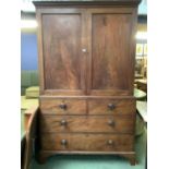 A large mahogany 2 door wardrobe, with 2 short above 2 long drawers