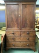 A large mahogany 2 door wardrobe, with 2 short above 2 long drawers