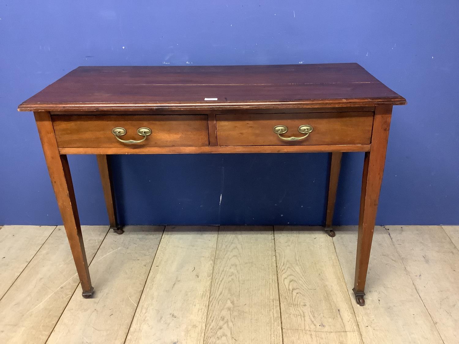 Small satinwood and inlaid writing desk, with tapered legs to castors and an inset tooled red