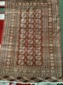 A small brown ground Braun rug purchased in Bahraine, vendor said their father bought it from the