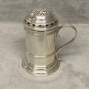 A sterling silver sugar shaker of pillar form with loop handle, Sheffield 1934 by Thomas