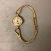 A 9ct gold cased wristwatch in a 20mm case, by Tatton, on an 18ct gold snake link bracelet