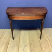 A D-end mahogany foldover tea table on reeded tapering legs, 68.5cm wide closed approx