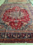 A large red Persian style rug, 300 x 380cm