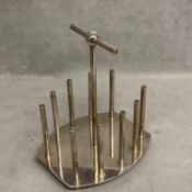 A silver plated toast rack, designed by Dr C Dresser, with kite mark to base, a stamped designed
