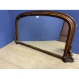 Arched shaped over mantle mirror, much wear to gilding, 101cm wide approx