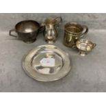 A collection of sterling silver items to include a presentation plate, christening mug , cream jug