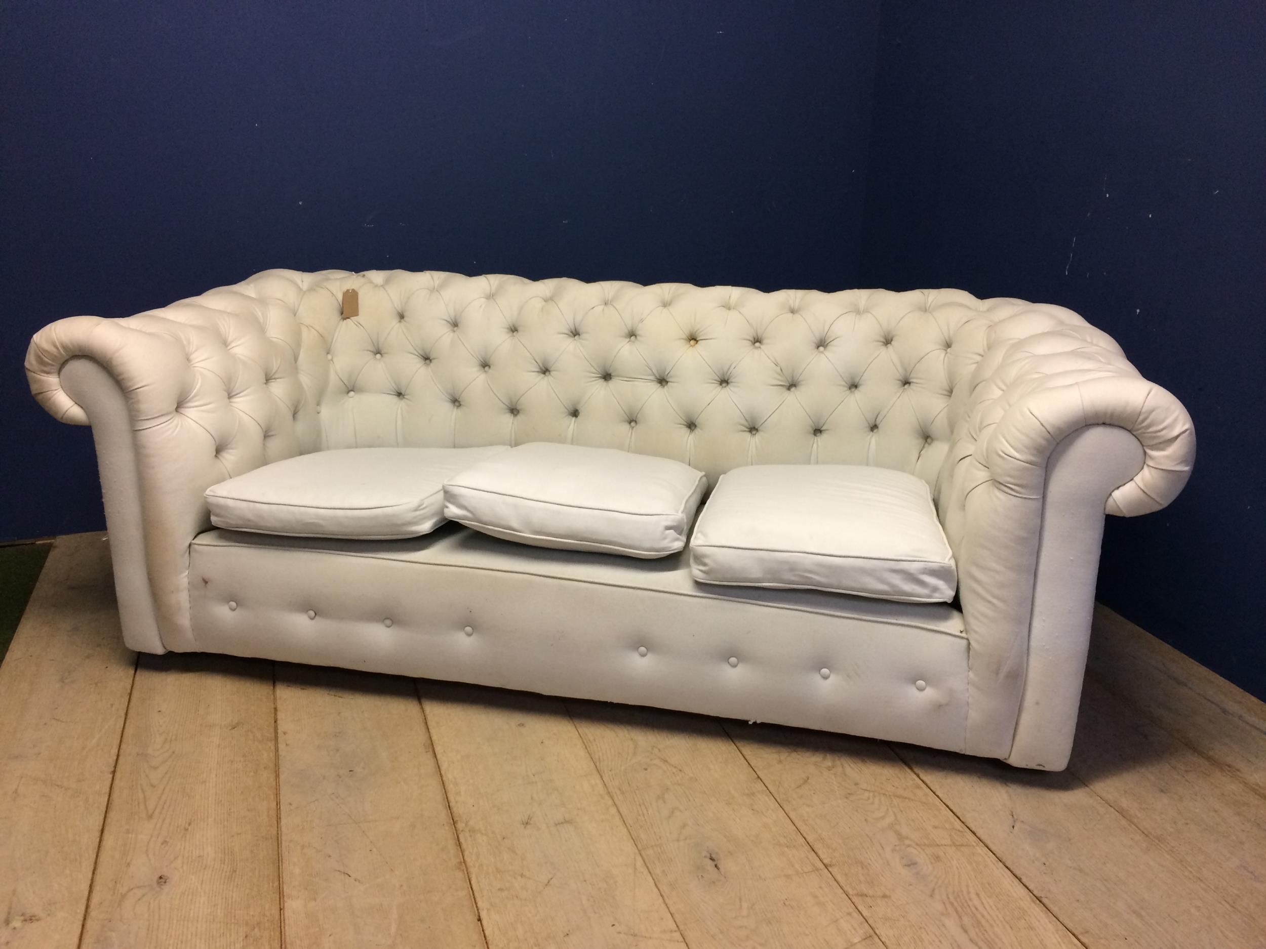 Victorian chesterfield sofa, upholstered in a light coloured fabric (some areas grubby with marks,