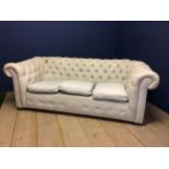 Victorian chesterfield sofa, upholstered in a light coloured fabric (some areas grubby with marks,