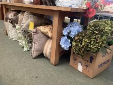 A quantity of cushions and ornamental flowers