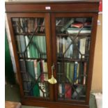 A mahogany and inlaid, astragal glazed bookcase, complete with vintage books of mixed titles,