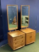 Two Ercol bedside chests/cupboards with long mirrors above each