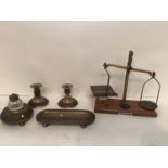 A garniture desk set of glass and brass inkwell, pen tidy, candlesticks, and a weighing scale, all