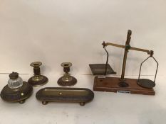 A garniture desk set of glass and brass inkwell, pen tidy, candlesticks, and a weighing scale, all