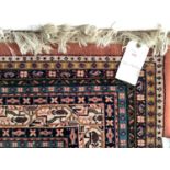 A large Indian style C20th brown central ground rug with stylized borders, 310 x 402cm