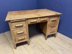 A rustic pine , 7 drawer, knee hole desk, with much staining and wear, 125cmL x 80xm D x 75cm H