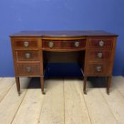 A 7 drawer mahogany and inlaid Edwardian style knee hole dressing table