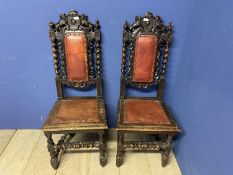 Pair of carved gothic style oak hall chairs with red leather inset seats. Damage to one, see images