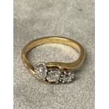 An unmarked yellow and white metal 3 stone diamond ring 3.9g, size Q approx