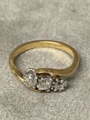 An unmarked yellow and white metal 3 stone diamond ring 3.9g, size Q approx