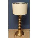 A Contemporary brass lamp with twist design column, and a cream shade, height overall 110cm; some