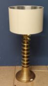 A Contemporary brass lamp with twist design column, and a cream shade, height overall 110cm; some