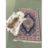 A Persian rug and a reindeer skin rug