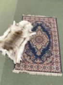 A Persian rug and a reindeer skin rug
