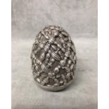 A modern Greek silver egg with raised knot work decoration, the base stamped A G 999 patented 231196