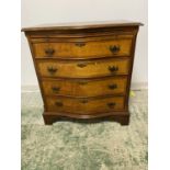 A modern, walnut veneered style, serpentine front chest of 4 drawers with brushing slide, some wear,