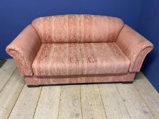 A pink upholstered settee, drop ends, 162cm Long