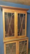 Two part faded mahogany and chequer board inlaid glazed bookcase; as found