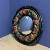 Decorative circular convex papier mache wall mirror with surround of embossed patterns of fruit 62cm