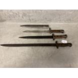 Three WW1 and WW2 rifle bayonets, one with original scabbard, longest 55cm