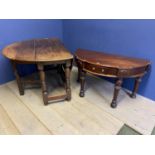 A heavy oak drop leaf dining table and a semi circular side table with central drawer