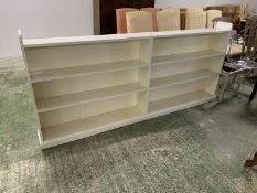 A long low white painted shelving unit, 229L x 96H cm approx.