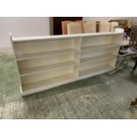 A long low white painted shelving unit, 229L x 96H cm approx.