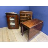 A mahogany drop leaf dining table, a glazed hanging corner cabinet and a chest of 2 short and 3 long