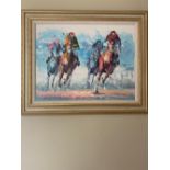 A modern picture in cream and gilt frame of galloping racehorses 49 X 64CM