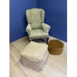 A green upholstered winged arm chair, a cream upholstered pouffe and another stool