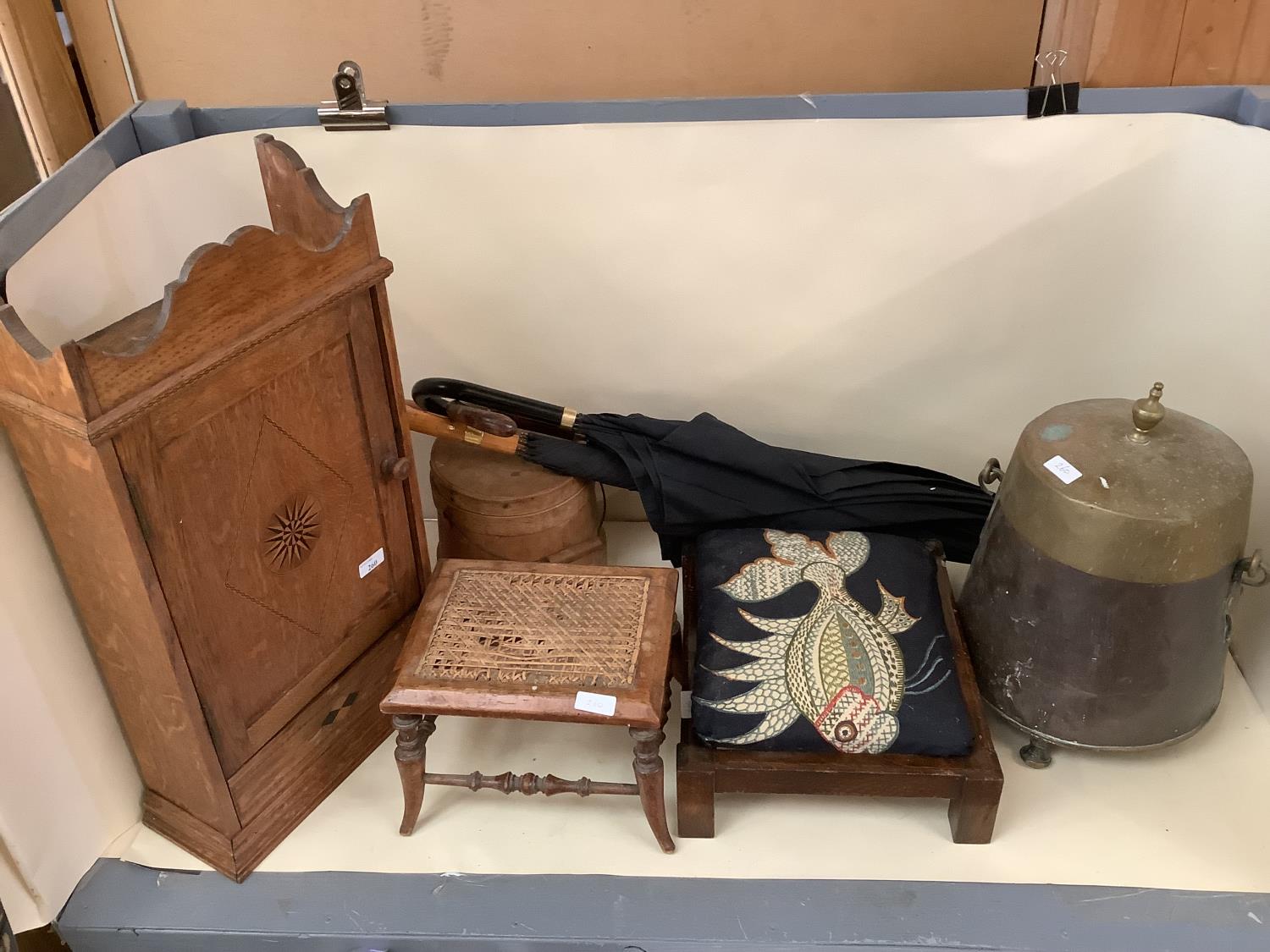 An inlaid hanging wall cupboard, a small footstool, with bergere - caning damaged, a foot stool