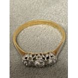 An 18ct gold and platinum 3 stone ring, 3 illusion set brilliant cut diamonds, 2.6g size P
