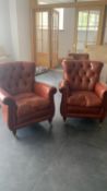 A pair of good tan leather club style arm chairs, with button backs, and brass studded scrolling