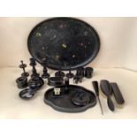 A black oval decorative papier mache tray together with turned ebonised wooden items. Tray 55 x 40cm