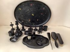 A black oval decorative papier mache tray together with turned ebonised wooden items. Tray 55 x 40cm